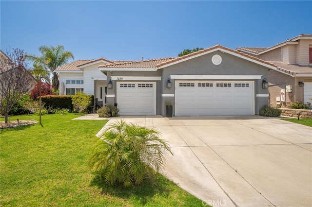 7256 Plumrose St, Fontana, CA 92336 - view of front of property featuring a garage, driveway, a tiled roof, a front lawn, and stucco siding