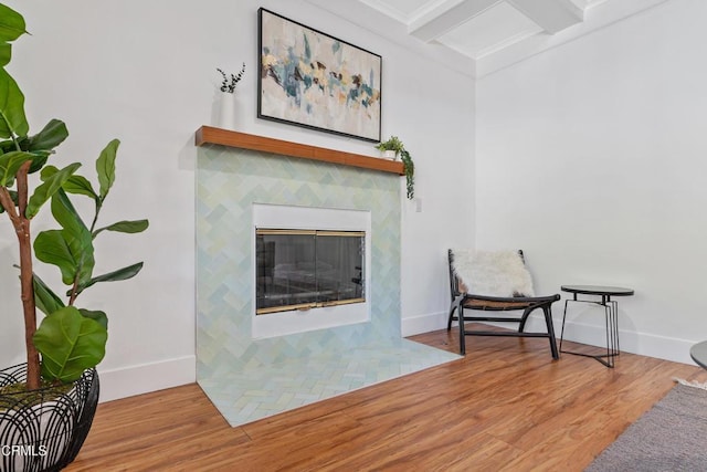1015 Nolden St, Highland Park, CA 90042 - living area featuring wood finished floors, a fireplace with flush hearth, and beamed ceiling