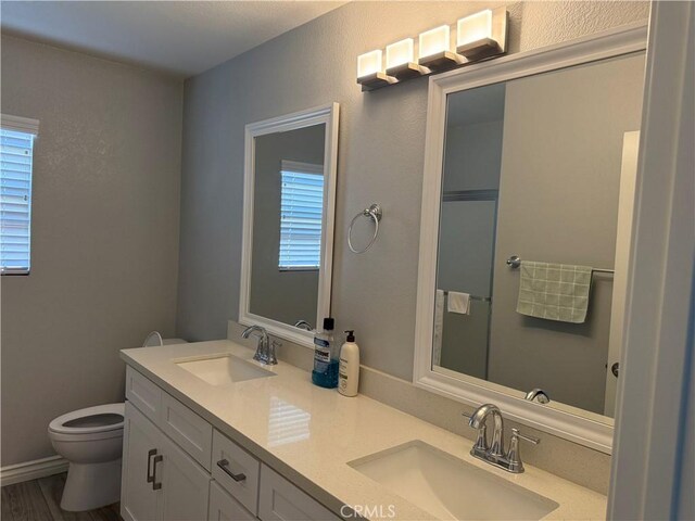 861 Moyano Cir, Corona, CA 92882 - full bathroom with double vanity, toilet, and wood finished floors