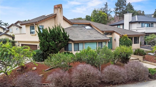 1555 Cordova Dr, San Luis Obispo, CA 93405 - back of property featuring a chimney, stucco siding, a garage, and a tile roof