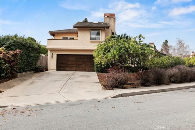 1555 Cordova Dr, San Luis Obispo, CA 93405 - view of front facade with an attached garage, stucco siding, driveway, and a chimney