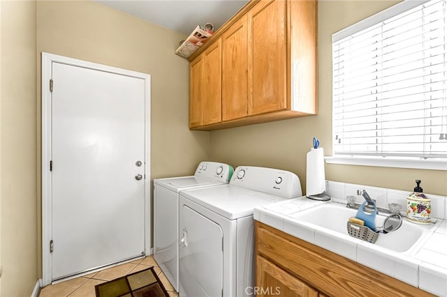10033 N Baird Ave, Fresno, CA 93730 - washroom with washer and dryer, cabinet space, and light tile patterned flooring