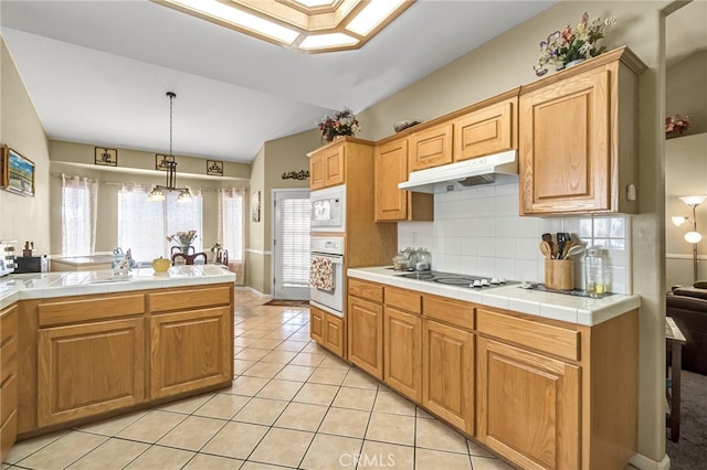 10033 N Baird Ave, Fresno, CA 93730 - kitchen featuring white appliances, under cabinet range hood, decorative backsplash, light tile patterned floors, and decorative light fixtures