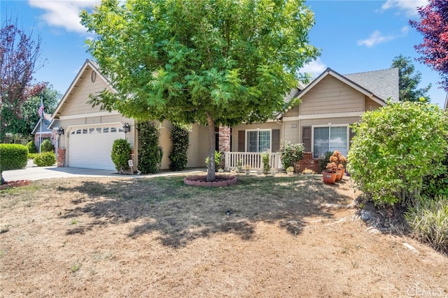 10033 N Baird Ave, Fresno, CA 93730 - view of front of home with a garage, driveway, brick siding, and a porch