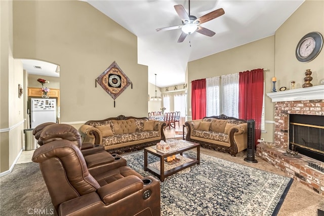 10033 N Baird Ave, Fresno, CA 93730 - living area with ceiling fan, carpet, arched walkways, a brick fireplace, and high vaulted ceiling