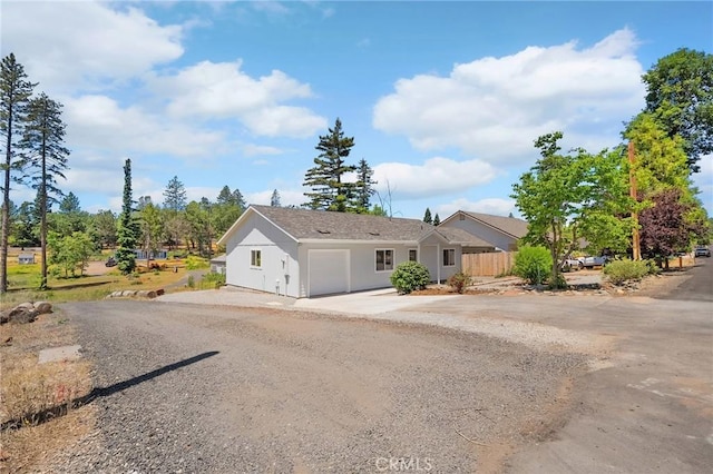 5821 Copeland Rd, Paradise, CA 95969 - ranch-style house with concrete driveway, a garage, and stucco siding
