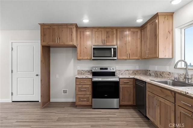 5821 Copeland Rd, Paradise, CA 95969 - kitchen featuring appliances with stainless steel finishes, light wood-type flooring, light stone counters, and recessed lighting