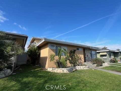 2809 W 141st Pl Unit 1, Gardena, CA 90249 - view of property exterior featuring a yard and stucco siding