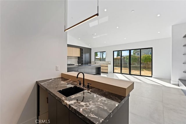 5275 Lynridge Dr, Yorba Linda, CA 92886 - kitchen featuring modern cabinets, a sink, a peninsula, dark stone countertops, and recessed lighting