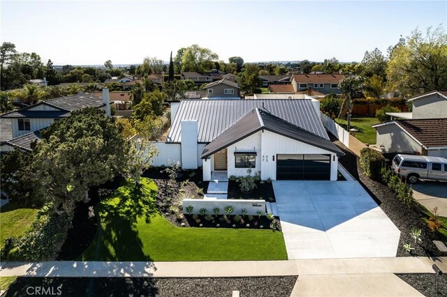 5275 Lynridge Dr, Yorba Linda, CA 92886 - view of front of home featuring a residential view, driveway, metal roof, a front lawn, and a garage