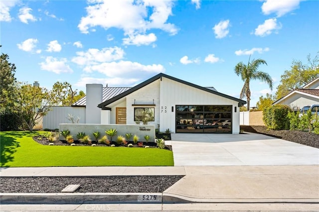 5275 Lynridge Dr, Yorba Linda, CA 92886 - view of front of house with a standing seam roof, driveway, an attached garage, and metal roof