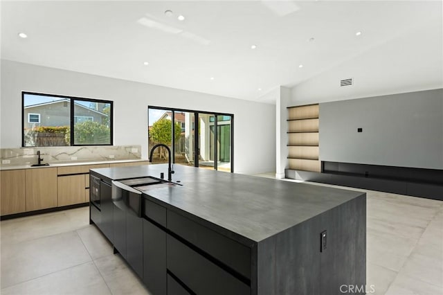 5275 Lynridge Dr, Yorba Linda, CA 92886 - kitchen with modern cabinets, a large island, light tile patterned floors, a sink, and lofted ceiling