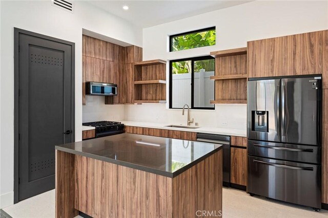 5275 Lynridge Dr, Yorba Linda, CA 92886 - kitchen with appliances with stainless steel finishes, open shelves, a sink, modern cabinets, and brown cabinets