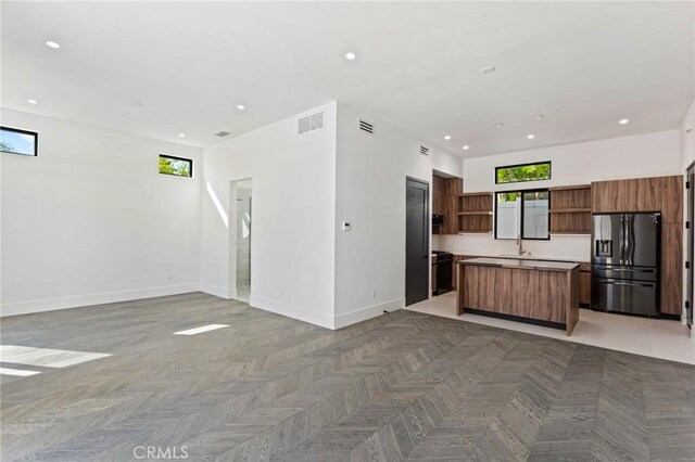 5275 Lynridge Dr, Yorba Linda, CA 92886 - kitchen with refrigerator with ice dispenser, open shelves, open floor plan, baseboards, and a center island