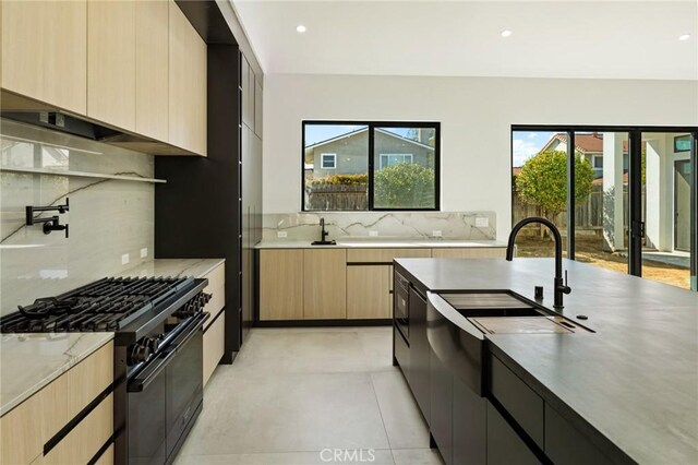 5275 Lynridge Dr, Yorba Linda, CA 92886 - kitchen with modern cabinets, black gas range, tasteful backsplash, light brown cabinets, and a sink