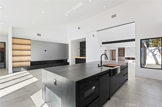 5275 Lynridge Dr, Yorba Linda, CA 92886 - kitchen with modern cabinets, open floor plan, a sink, a large island with sink, and high vaulted ceiling