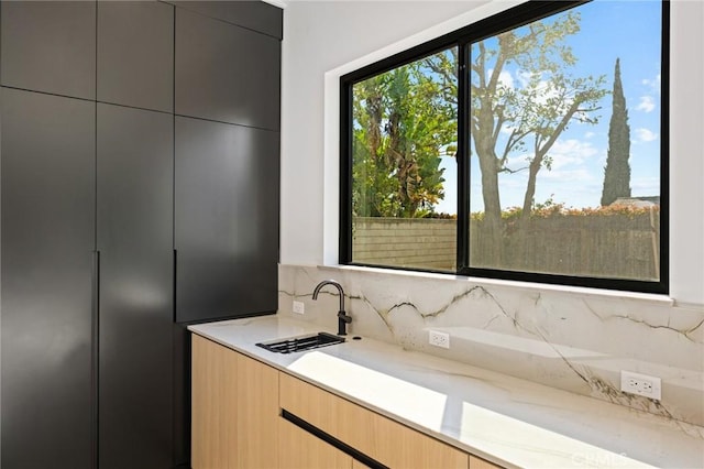 5275 Lynridge Dr, Yorba Linda, CA 92886 - kitchen featuring modern cabinets, a sink, light stone countertops, and tasteful backsplash