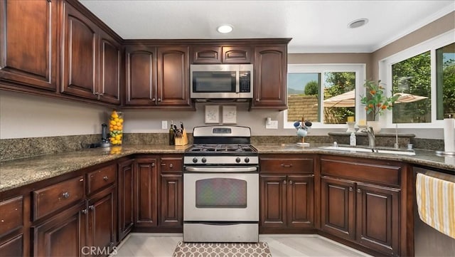 10226 Northridge Dr, Rancho Cucamonga, CA 91737 - kitchen featuring stainless steel appliances, a sink, dark brown cabinets, crown molding, and dark stone countertops
