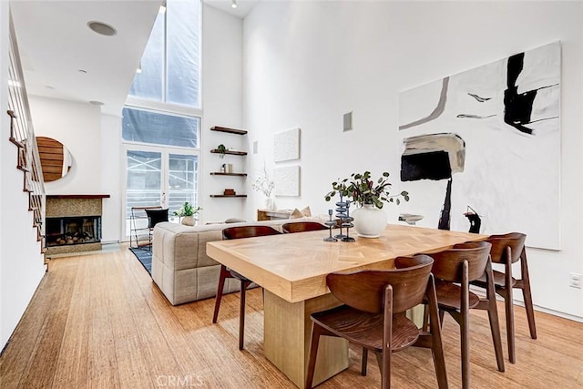 1436 N Detroit St Unit 2, Los Angeles, CA 90046 - dining room featuring a high ceiling, light wood finished floors, and a multi sided fireplace
