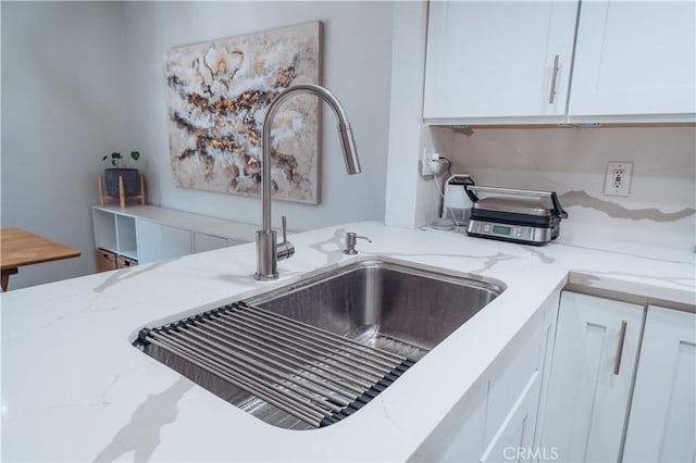 25598 Mont Pointe Unit 4E, Lake Forest, CA 92630 - kitchen view of a sink, white cabinets, and light stone countertops
