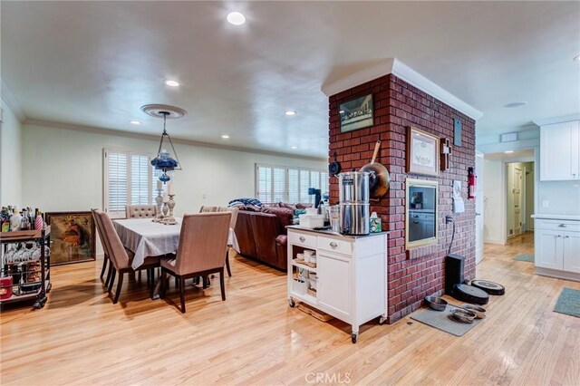 12438 Lambert Cir, Garden Grove, CA 92841 - kitchen featuring white cabinets, a fireplace, crown molding, light wood finished floors, and recessed lighting