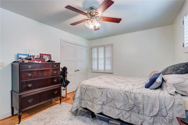 12438 Lambert Cir, Garden Grove, CA 92841 - bedroom with wood finished floors, multiple windows, a closet, and ceiling fan