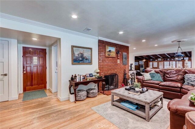 12438 Lambert Cir, Garden Grove, CA 92841 - living area with light wood-style floors, baseboards, recessed lighting, crown molding, and a brick fireplace