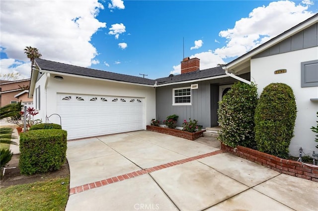 12438 Lambert Cir, Garden Grove, CA 92841 - ranch-style house featuring concrete driveway, a chimney, an attached garage, and board and batten siding