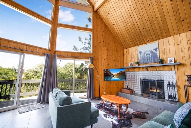 26503 Amador Ln, Lake Arrowhead, CA 92352 - tiled living room with high vaulted ceiling, wood walls, a tiled fireplace, and wood ceiling