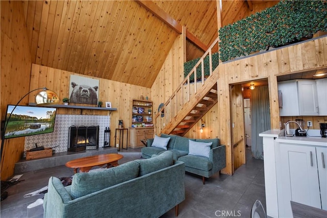 26503 Amador Ln, Lake Arrowhead, CA 92352 - living room featuring stairway, wood walls, high vaulted ceiling, wooden ceiling with exposed beams, and a tiled fireplace