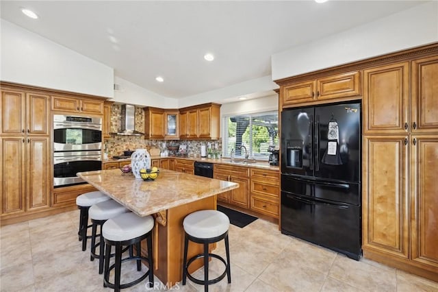 6752 Laurelbrook Dr, Riverside, CA 92506 - kitchen featuring black appliances, wall chimney range hood, brown cabinets, lofted ceiling, and light stone countertops