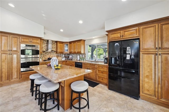 6752 Laurelbrook Dr, Riverside, CA 92506 - kitchen featuring black appliances, wall chimney range hood, brown cabinets, vaulted ceiling, and light stone counters