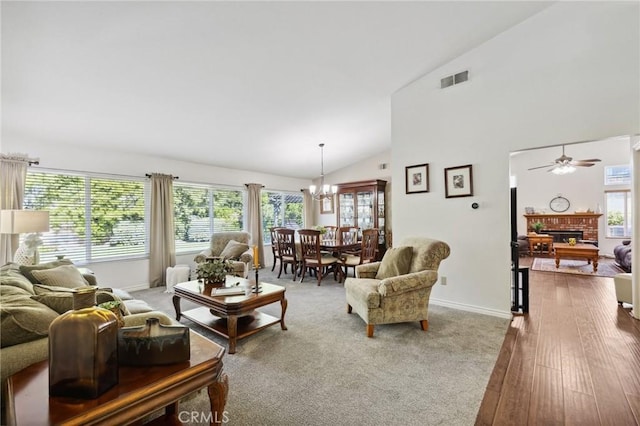 6752 Laurelbrook Dr, Riverside, CA 92506 - living room featuring a fireplace, a chandelier, ceiling fan, high vaulted ceiling, and wood finished floors