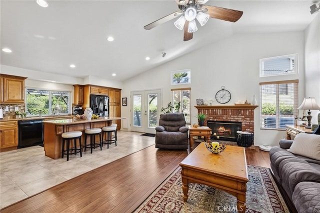 6752 Laurelbrook Dr, Riverside, CA 92506 - living area featuring recessed lighting, a brick fireplace, light wood finished floors, high vaulted ceiling, and a ceiling fan