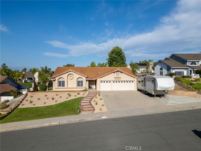 6752 Laurelbrook Dr, Riverside, CA 92506 - view of front of property featuring an attached garage, stucco siding, driveway, and a residential view