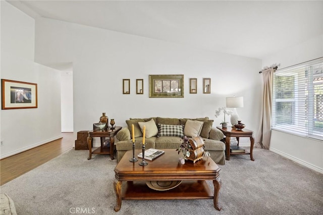 6752 Laurelbrook Dr, Riverside, CA 92506 - carpeted living area featuring vaulted ceiling and baseboards