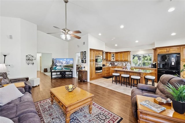 6752 Laurelbrook Dr, Riverside, CA 92506 - living room featuring light wood finished floors, a ceiling fan, high vaulted ceiling, and recessed lighting