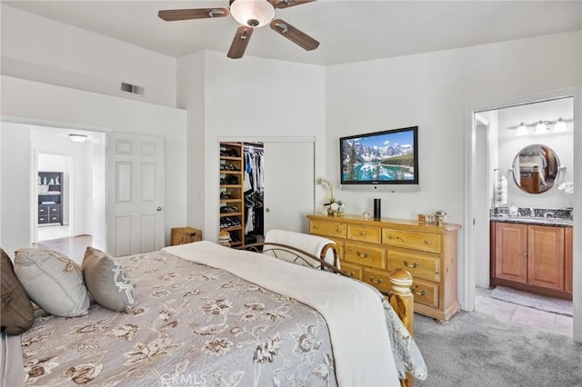6752 Laurelbrook Dr, Riverside, CA 92506 - bedroom with light colored carpet, a closet, connected bathroom, ceiling fan, and light tile patterned flooring