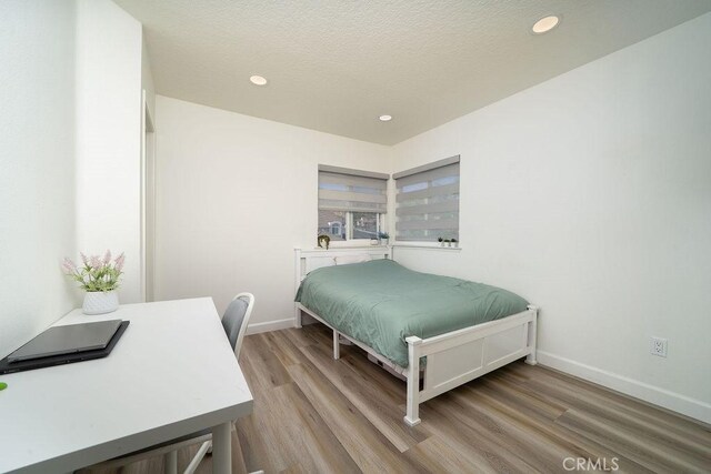 6678 Wrangler Rd, Chino Hills, CA 91709 - bedroom with wood finished floors, recessed lighting, and a textured ceiling