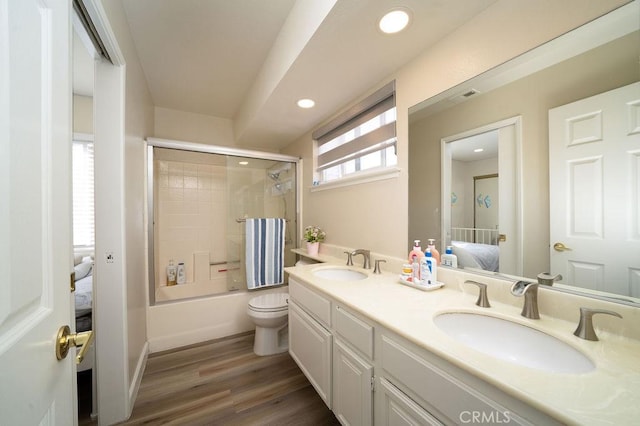 6678 Wrangler Rd, Chino Hills, CA 91709 - ensuite bathroom with double vanity, combined bath / shower with glass door, wood finished floors, and recessed lighting