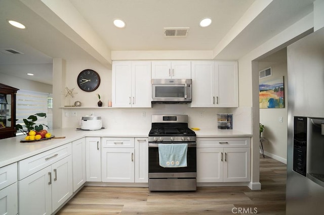 6678 Wrangler Rd, Chino Hills, CA 91709 - kitchen featuring appliances with stainless steel finishes, light countertops, white cabinetry, light wood-type flooring, and recessed lighting