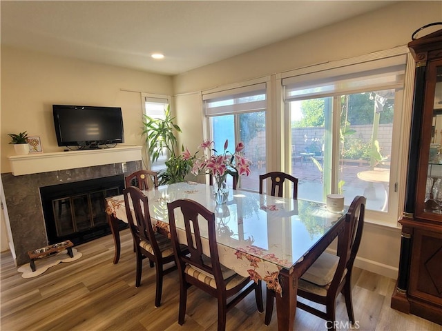 6678 Wrangler Rd, Chino Hills, CA 91709 - dining room with light wood-type flooring, a fireplace, and recessed lighting