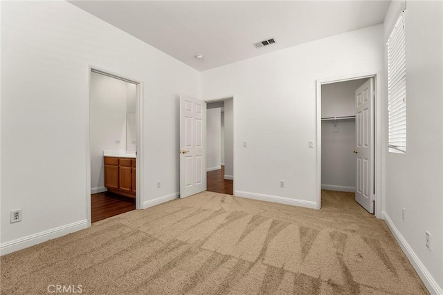 10858 Sinclare Cir, Loma Linda, CA 92354 - unfurnished bedroom featuring carpet, a spacious closet, multiple windows, and ensuite bath