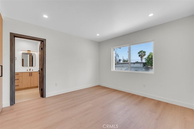 11240 Lull St, Sun Valley, CA 91352 - empty room featuring light wood-style floors, recessed lighting, baseboards, and a sink