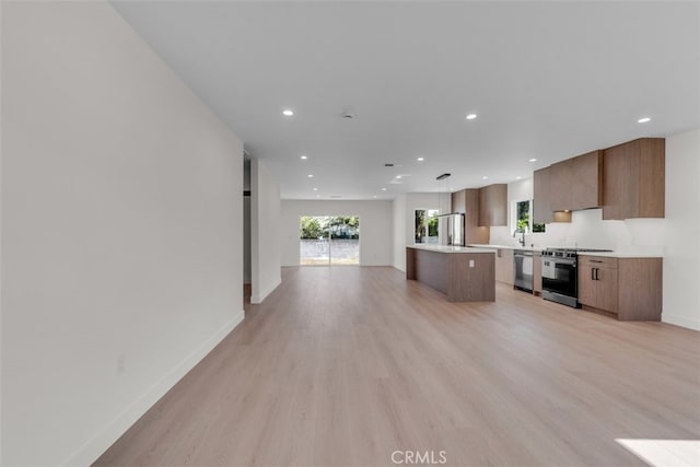 11240 Lull St, Sun Valley, CA 91352 - kitchen featuring stainless steel appliances, open floor plan, light countertops, recessed lighting, and a kitchen island