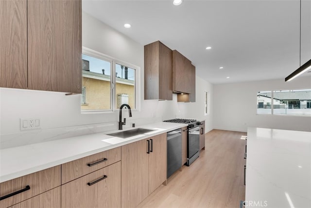 11240 Lull St, Sun Valley, CA 91352 - kitchen with gas range, a sink, light wood-style flooring, dishwasher, and modern cabinets