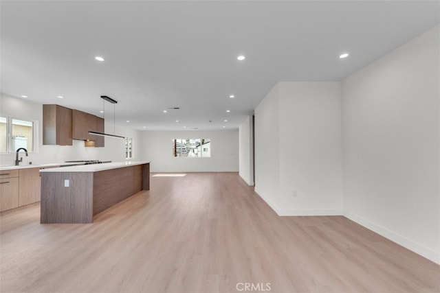 11240 Lull St, Sun Valley, CA 91352 - kitchen with modern cabinets, a center island, open floor plan, light countertops, and healthy amount of natural light