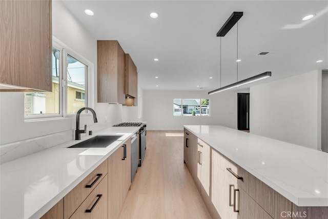 11240 Lull St, Sun Valley, CA 91352 - kitchen featuring modern cabinets, a sink, light wood-type flooring, healthy amount of natural light, and recessed lighting