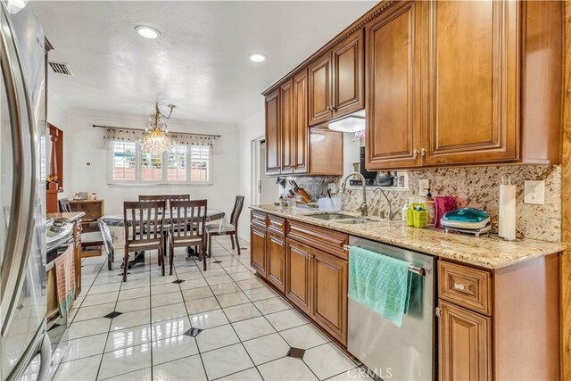 15112 Alderpoint Dr, La Mirada, CA 90638 - kitchen featuring stainless steel appliances, tasteful backsplash, brown cabinets, ornamental molding, and light stone countertops