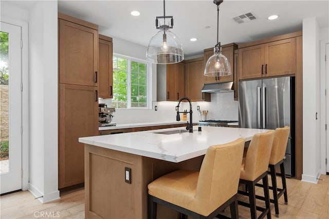 1146 E Cove Pl, Encinitas, CA 92024 - kitchen featuring freestanding refrigerator, a sink, under cabinet range hood, light wood-type flooring, and hanging light fixtures